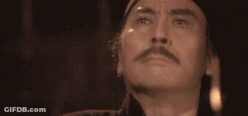 A Close Up Of A Man 'S Face With His Eyes Closed And A Mustache GIF