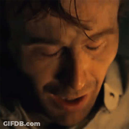 A Close Up Of A Man 'S Face With His Eyes Closed And A Shadow On His Face . GIF