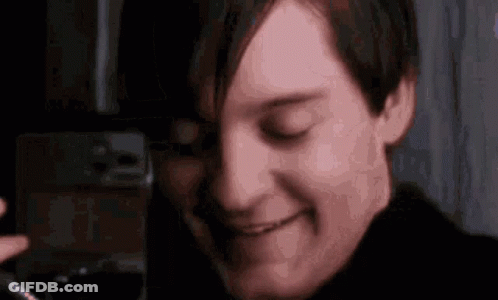 A Close Up Of A Man 'S Face With His Eyes Closed And A Smile On His Face . GIF
