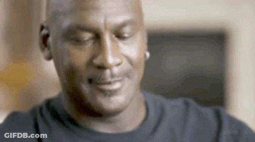 A Close Up Of A Man 'S Face With His Eyes Closed And A Smile On His Face . GIF