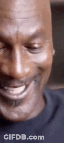 A Close Up Of A Man 'S Face With His Eyes Closed And A Smile On His Face . GIF