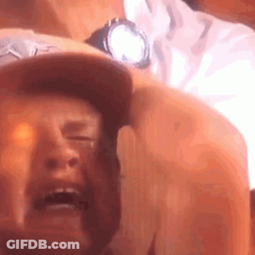 A Close Up Of A Man 'S Face With His Eyes Closed And A Watch On His Wrist . GIF