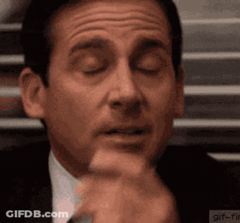 A Close Up Of A Man 'S Face With His Eyes Closed And His Hand On His Chin . GIF
