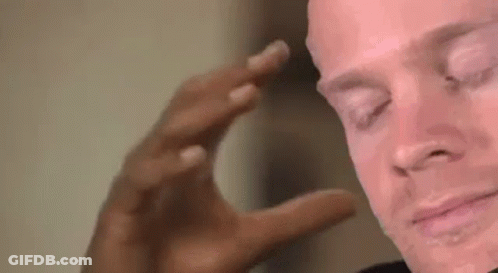 A Close Up Of A Man 'S Face With His Eyes Closed And His Hand On His Head . GIF