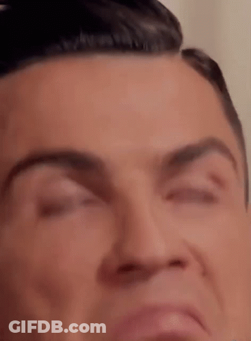 A Close Up Of A Man 'S Face With His Eyes Closed And His Mouth Open . GIF