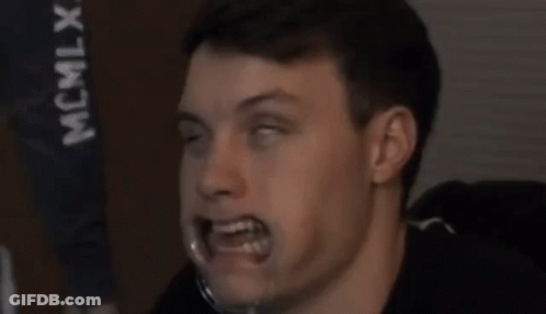 A Close Up Of A Man 'S Face With His Eyes Closed And His Mouth Open . GIF