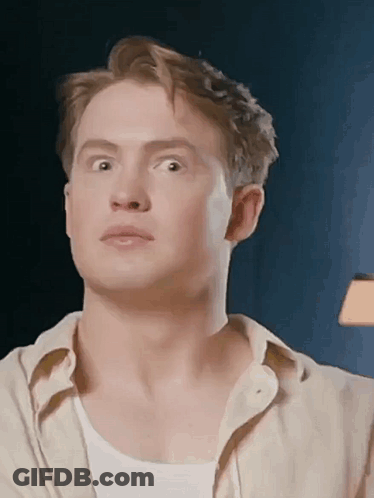 A Close Up Of A Man 'S Face With His Eyes Closed And His Mouth Open . GIF