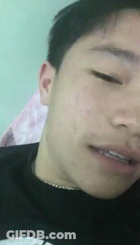 A Close Up Of A Man 'S Face With His Eyes Closed And His Mouth Open GIF