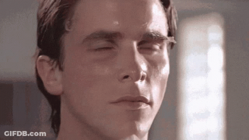 A Close Up Of A Man 'S Face With His Eyes Closed And His Mouth Open . GIF