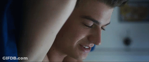 A Close Up Of A Man 'S Face With His Eyes Closed And Smiling GIF