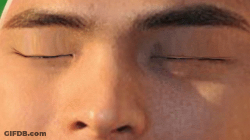 A Close Up Of A Man 'S Face With His Eyes Closed GIF