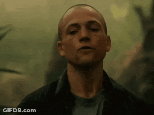 A Close Up Of A Man 'S Face With His Eyes Closed In A Dark Room GIF