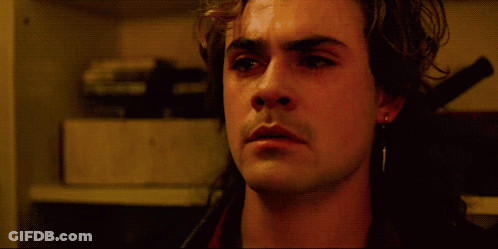 A Close Up Of A Man 'S Face With His Eyes Closed In A Dark Room GIF