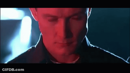 A Close Up Of A Man 'S Face With His Eyes Closed In A Dark Room GIF