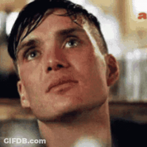 A Close Up Of A Man 'S Face With His Eyes Closed Looking Up . GIF