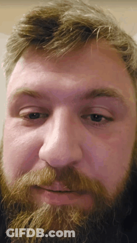 A Close Up Of A Man 'S Face With His Eyes Closed GIF