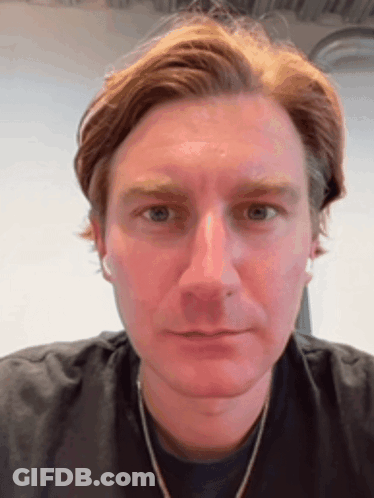 A Close Up Of A Man 'S Face With His Eyes Closed GIF