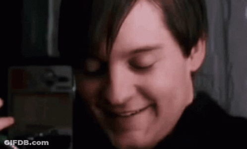 A Close Up Of A Man 'S Face With His Eyes Closed Smiling . GIF