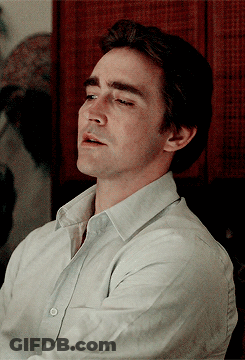 A Close Up Of A Man 'S Face With His Eyes Closed Wearing A White Shirt GIF