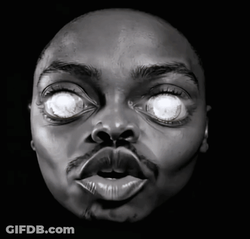 A Close Up Of A Man 'S Face With His Eyes Glowing GIF