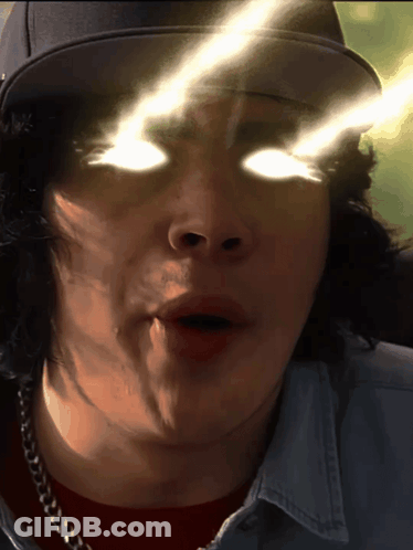 A Close Up Of A Man 'S Face With His Eyes Glowing GIF
