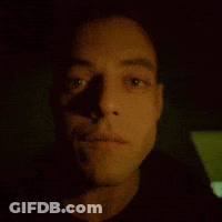 A Close Up Of A Man 'S Face With His Eyes Looking At The Camera GIF