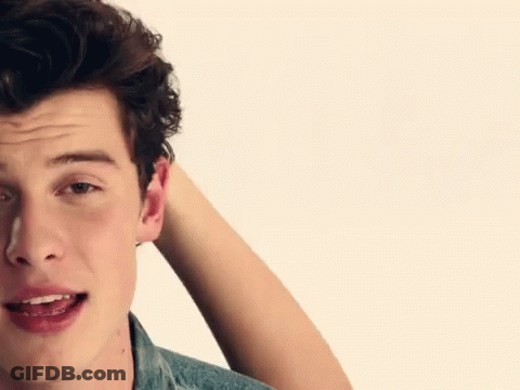 A Close Up Of A Man 'S Face With His Hand In His Hair GIF