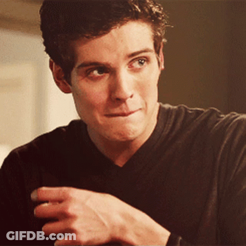 A Close Up Of A Man 'S Face With His Hand On His Chin GIF