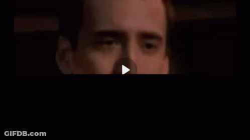 A Close Up Of A Man 'S Face With His Hand On His Mouth . GIF