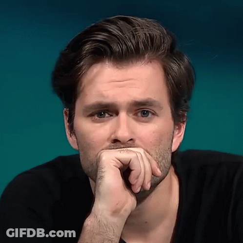 A Close Up Of A Man 'S Face With His Hand On His Mouth GIF