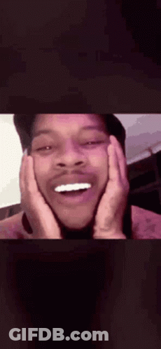 A Close Up Of A Man 'S Face With His Hands On His Face And His Mouth Open . GIF