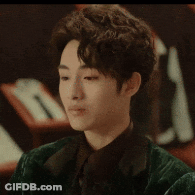 A Close Up Of A Man 'S Face With His Hands On His Face . GIF