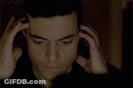 A Close Up Of A Man 'S Face With His Hands On His Head .. GIF