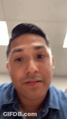 A Close Up Of A Man 'S Face With His Mouth Open GIF