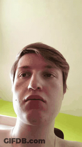 A Close Up Of A Man 'S Face With His Mouth Open GIF