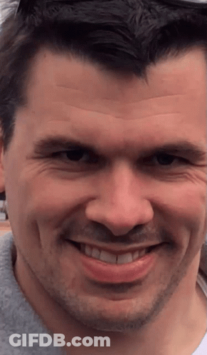 A Close Up Of A Man 'S Face With His Mouth Open GIF