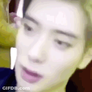 A Close Up Of A Man 'S Face With His Mouth Open And A Blurry Background . GIF
