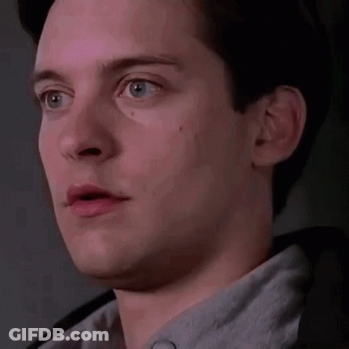 A Close Up Of A Man 'S Face With His Mouth Open And A Gray Shirt On . GIF