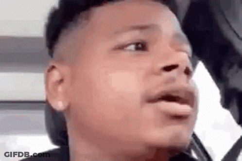 A Close Up Of A Man 'S Face With His Mouth Open And A Hat On . GIF