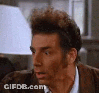 A Close Up Of A Man 'S Face With His Mouth Open And A Lamp In The Background . GIF