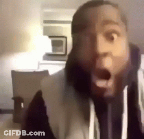 A Close Up Of A Man 'S Face With His Mouth Open And A Surprised Look On His Face . GIF