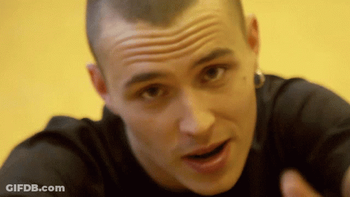 A Close Up Of A Man 'S Face With His Mouth Open And A Yellow Background GIF