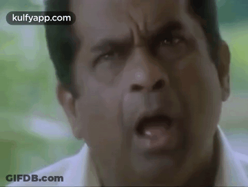 A Close Up Of A Man 'S Face With His Mouth Open And His Eyes Closed . GIF