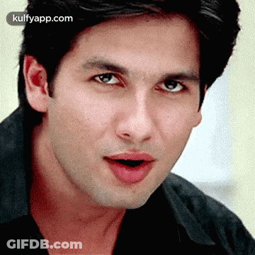 A Close Up Of A Man 'S Face With His Mouth Open And His Eyes Closed . GIF