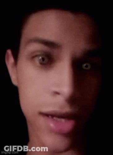 A Close Up Of A Man 'S Face With His Mouth Open And His Eyes Looking At The Camera . GIF