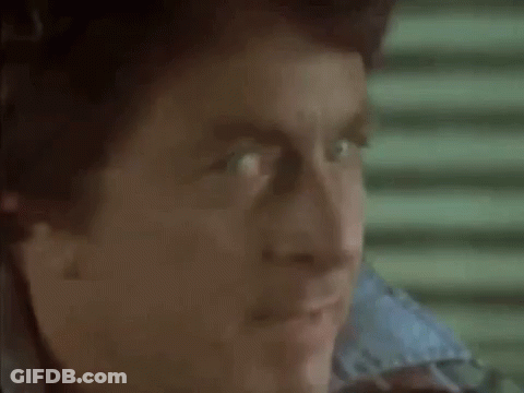 A Close Up Of A Man 'S Face With His Mouth Open And His Eyes Looking At The Camera . GIF