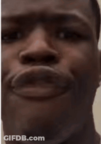 A Close Up Of A Man 'S Face With His Mouth Open And His Eyes Looking At The Camera . GIF