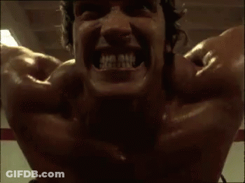 A Close Up Of A Man 'S Face With His Mouth Open And His Teeth Showing . GIF