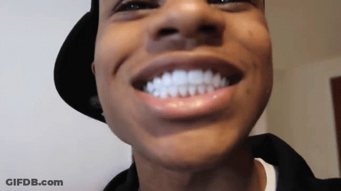 A Close Up Of A Man 'S Face With His Mouth Open And His Teeth Visible . GIF