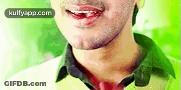 A Close Up Of A Man 'S Face With His Mouth Open And His Tongue Sticking Out . GIF